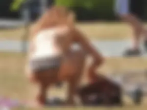 Lady at the park stripping down to her bikini to lay out