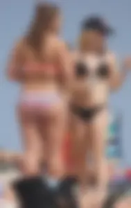 Two thick white girls in bikinis on the beach with big asses