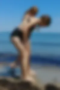 2 sexy friends in bikinis walking on the beach
