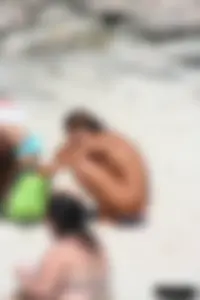 Older lady on a nude beach showing her body