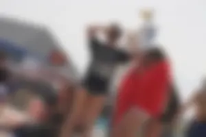 A group of teens in bikinis on the beach