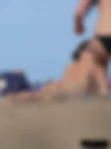 Sexy babe with a nice body topless and in a thong on the beach