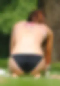 Sexy milf getting some sun in a bikini at the park