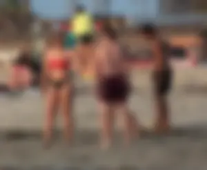 Thick white girls ass in a black thong bikini at the beach