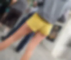 Skinny ass eating her yellow shorts