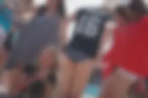 A group of teens in bikinis on the beach