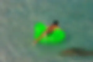 FKK Nudists playing in the water with floater