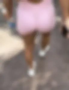 Latina with a bubble in a one piece at amusement park