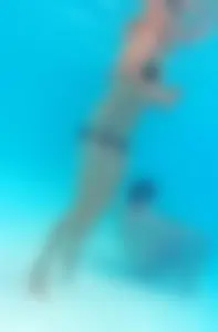 Underwater shots of a bikini teen swimming in the pool