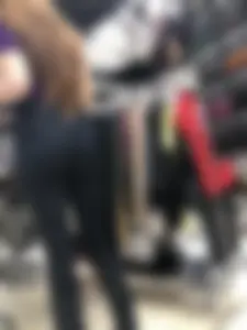 Cute candid shop assistant wearing boots and tight pants