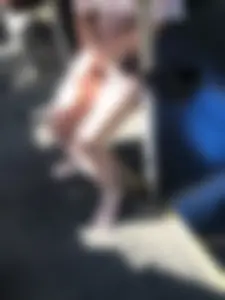 Young Girl in Sandals and Shorts in a Public Bus