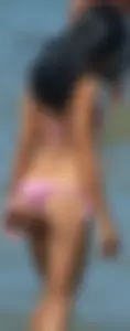 Little brunette ass in a pink bikini at the beach