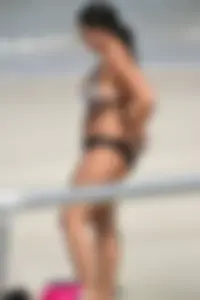 Blonde and brunette on the beach looking sexy in their bikinis