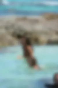 Nude beach ladies in the water showing their tits
