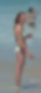 Milf at the beach in the water with hard nipples and a nice body