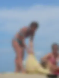 Sexy lady on the beach in a blue thong bikini