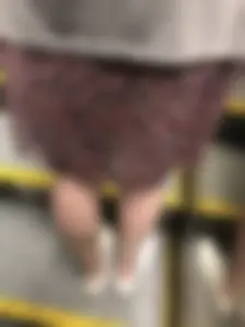 Thin Legs in a Skirt on a Subway Escalator Closeup Photos
