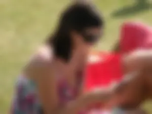 Milf in Sunglasses Reading in the Park Sideboob Photo