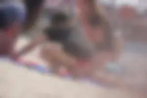 A group of teens in bikinis on the beach