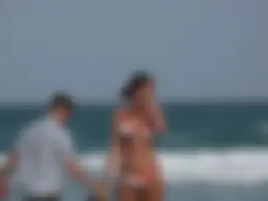 Skinny and sexy lady in a bikini playing on the beach