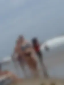 Big boobed girl on the beach in blue and black bikini