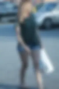 Cutie walking in the parking lot in jean shorts