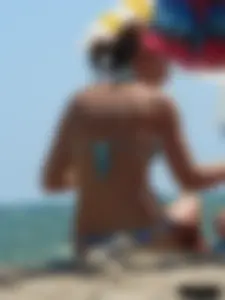 A bunch of hot babes on the beach in thong bikinis