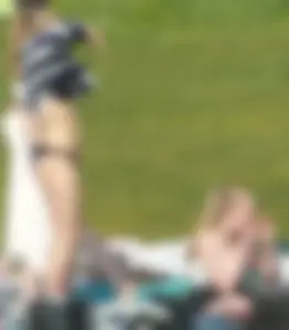 Teen taking off her dress in the park