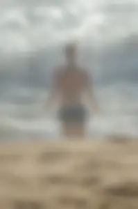 Blonde lady on the beach in bikini top and spandex shorts with a nice gap