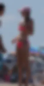 Sexy and skinny girl on the beach in pink bikini