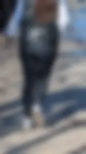 A beautiful little brunette walking in the park. tight black leggings