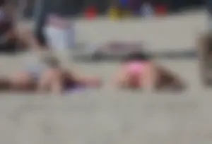 Sexy brunette on the beach in a bikini with great tits