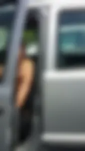 Pretty babe with small boobs in black top getting out of her car