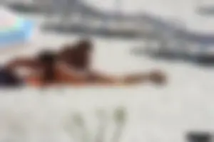 Topless milf and her topless daughter on the beach