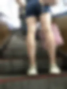 Candid Girl in Denim Shorts and Sneakers Standing on the Escalator - Hot Legs Closeups
