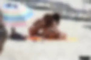 Topless milf and her topless daughter on the beach