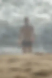Blonde lady on the beach in bikini top and spandex shorts with a nice gap