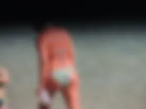 Blonde milf on the beach in her bikini