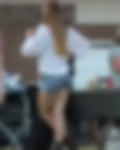 Hippie type dressed girl in denim shorts with a nice ass