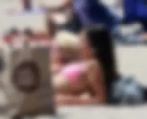 Sexy brunette on the beach in a bikini with great tits