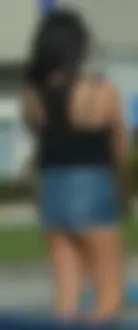 Brunette in short denim shorts showing a little cheek