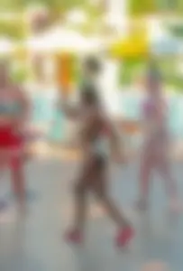 Big boobed blonde milf dancing by the pool in a bikini