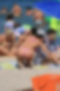 Sexy milf in pink thong bikini on the beach