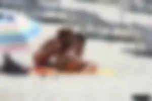 Topless milf and her topless daughter on the beach