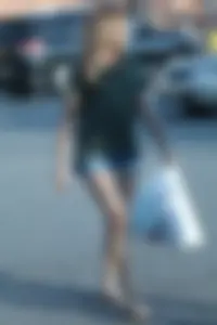 Cutie walking in the parking lot in jean shorts
