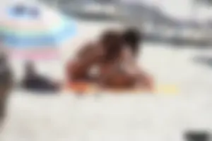 Topless milf and her topless daughter on the beach