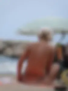 Tattooed blonde with big tits topless and in thong