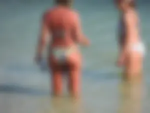 Blonde milf on the beach in her bikini