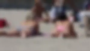 Sexy brunette on the beach in a bikini with great tits