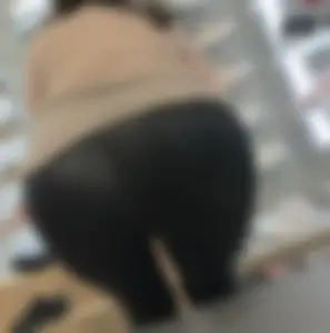 Latina milf in see leather see thru leggings sitting down.